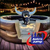 Inflatable bull ride with Astro Jump logo at night with string lights