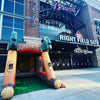 Inflatable bat and ball structure in front of a stadium with 'Braves' branding.