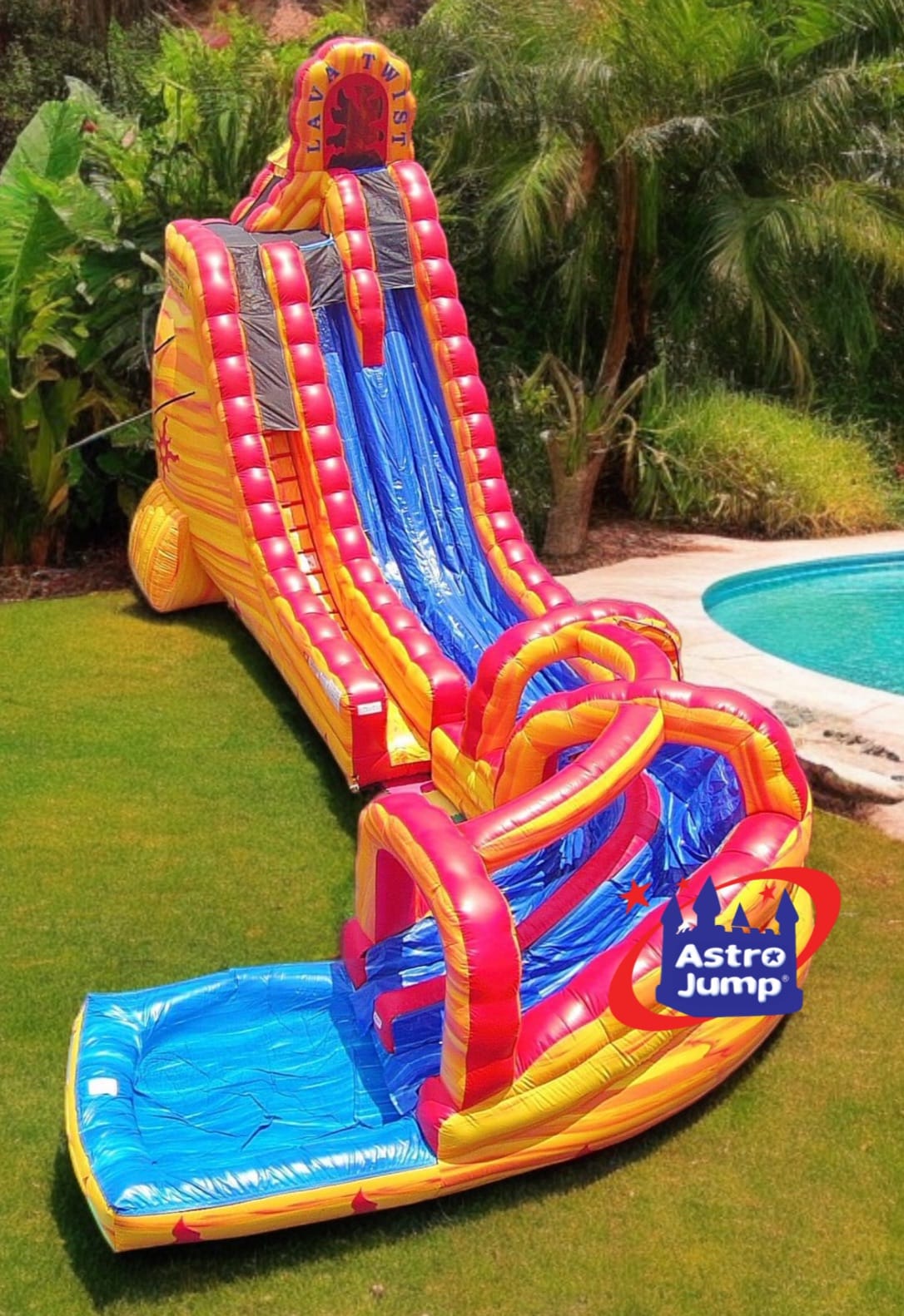 Colorful inflatable slide with pool at the bottom on a grassy area