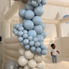 Balloon garland and white bounce house rental at a kids birthday party in Atlanta