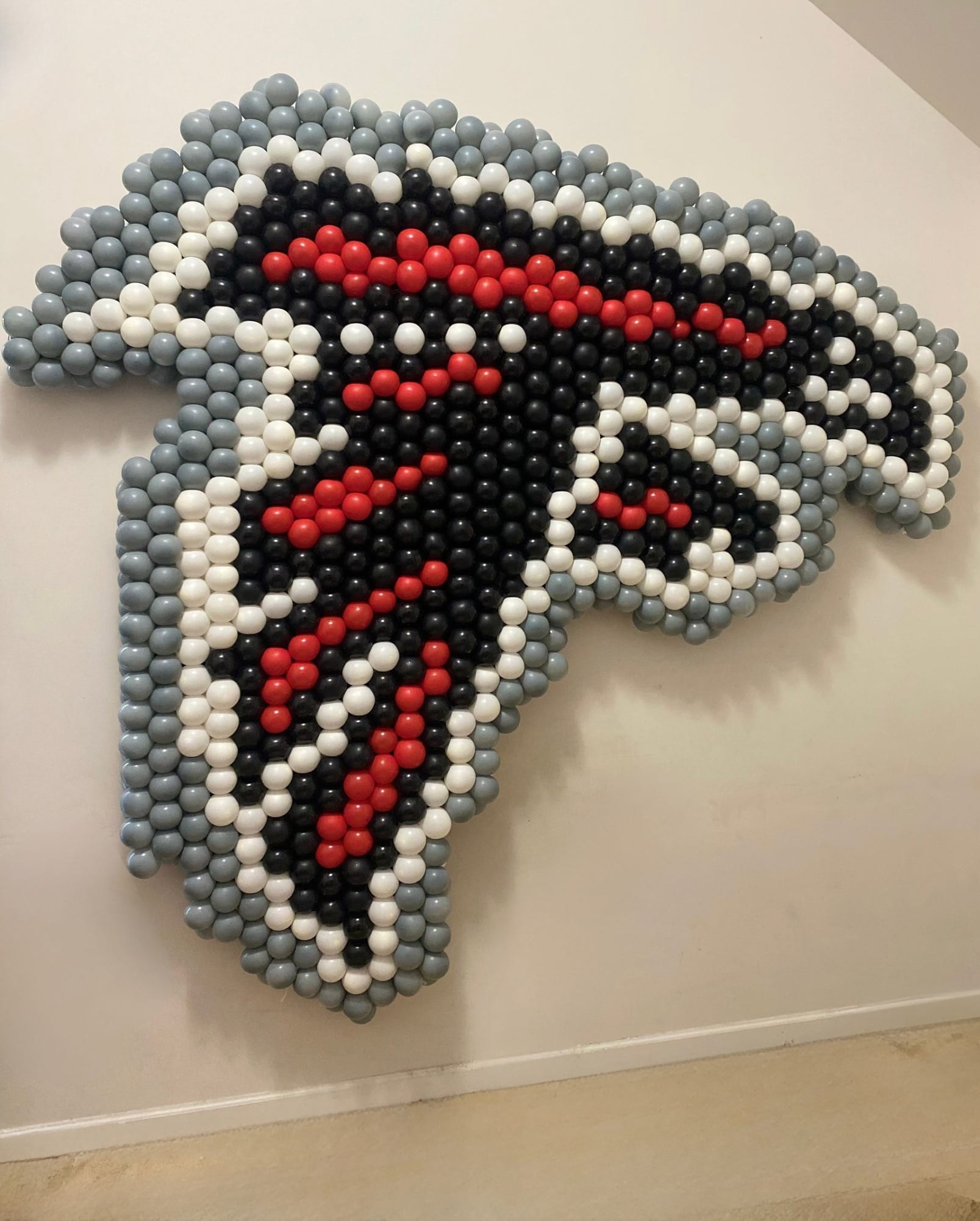 Atlanta Falcons logo made of colorful balloons on a white wall