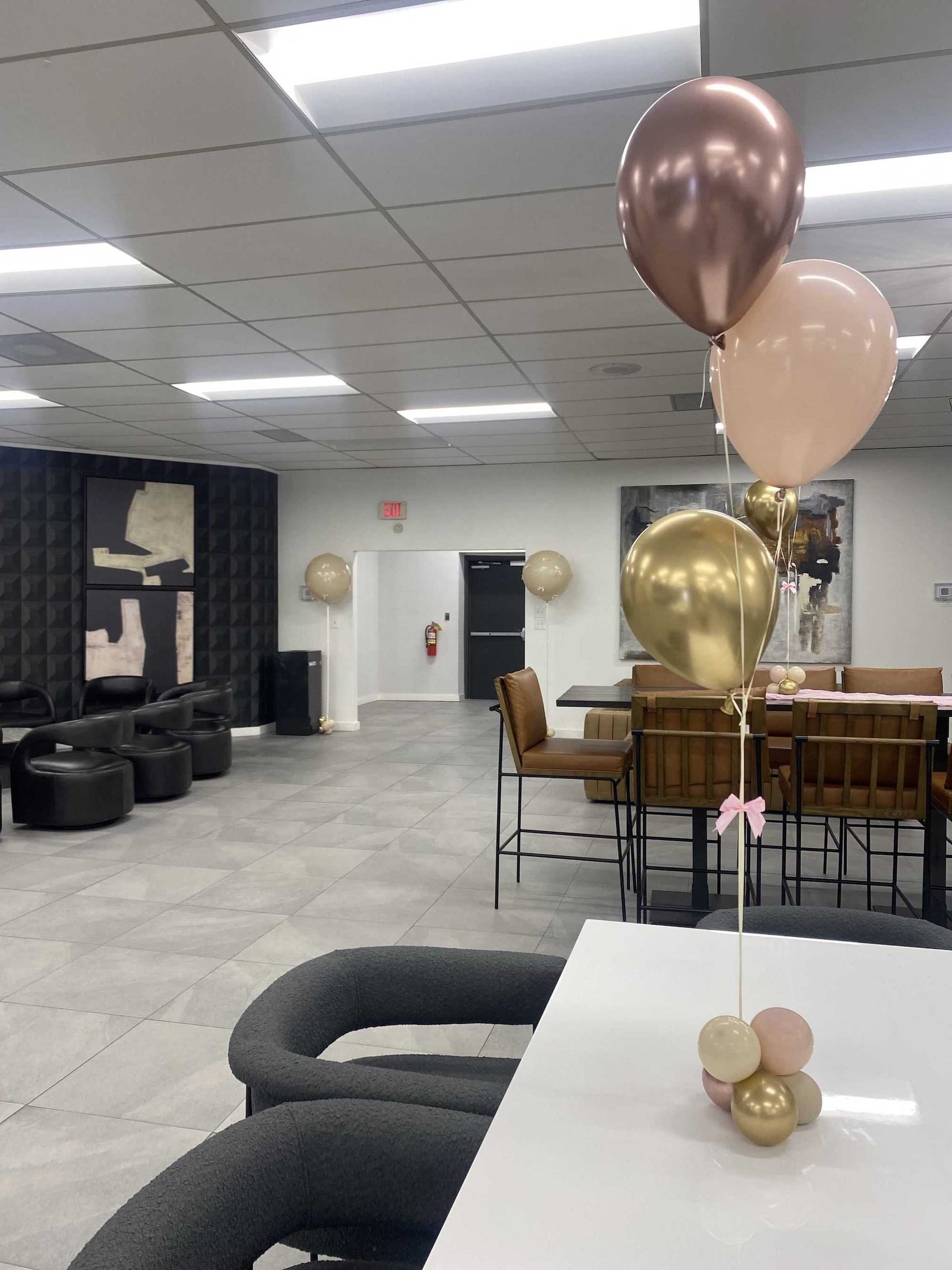 Modern office space with balloons on a table for a baby shower in Atlanta.