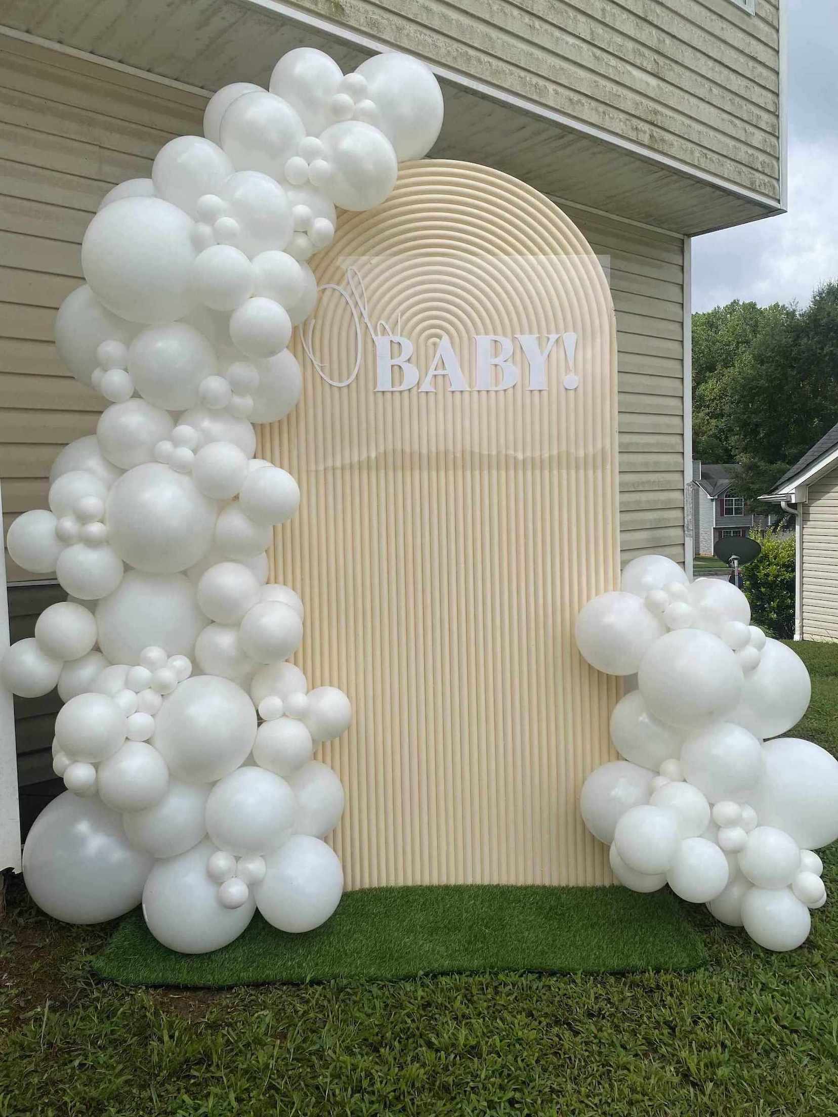 Balloon arch with 'BABY!' sign in front of a house for a baby shower in Atlanta.