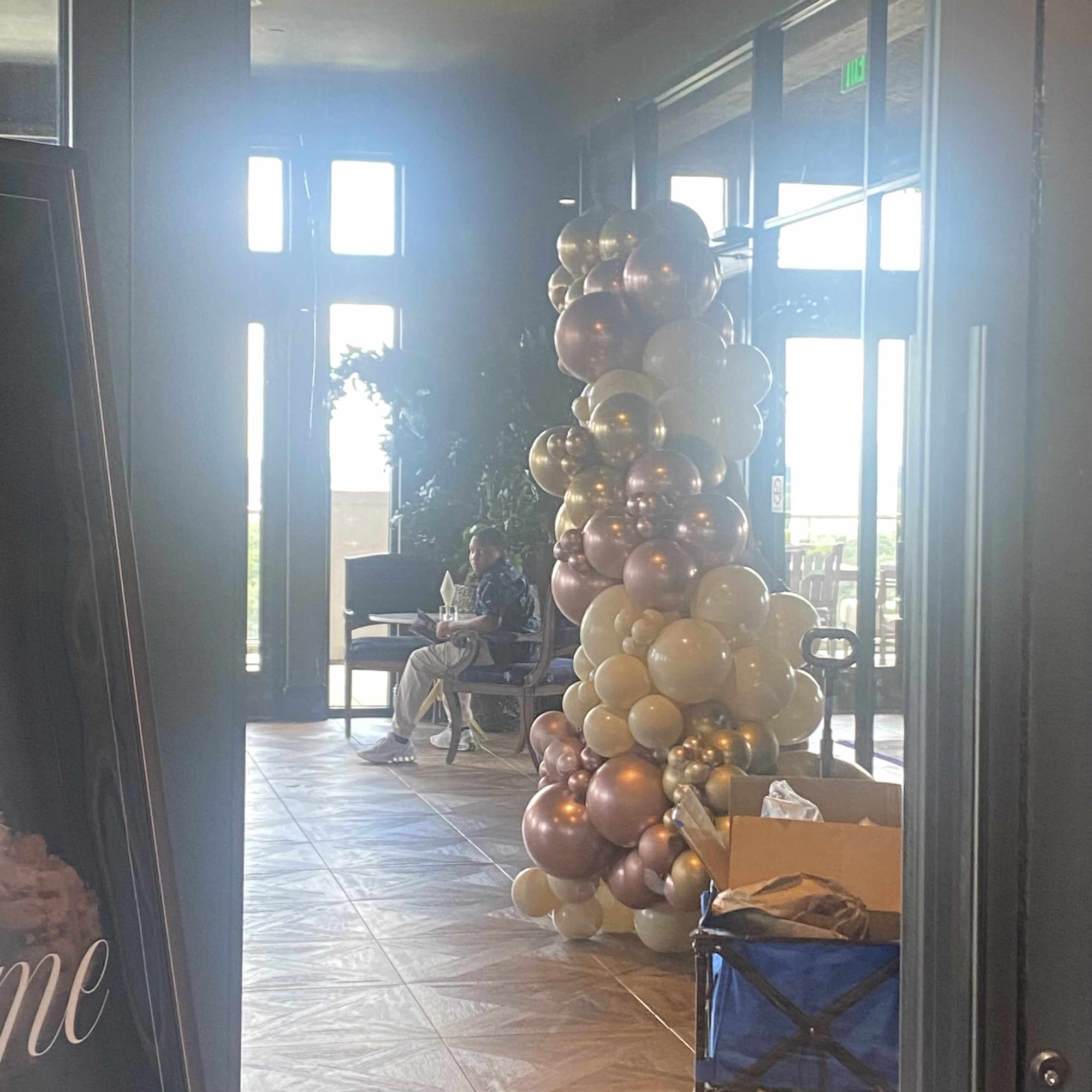 Balloon archway in a room with large windows for a graduation party in Atlanta.