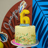 Birthday cake with custom cake topper number '6' topper against a colorful background