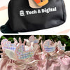 Black pouch with 'Tech & Digital' branding and pink bags with decorative tags on a white background
