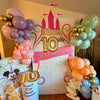 Decorative setup for Taliana's 10th Golden Birthday with balloons and a castle-themed backdrop for a 10 year old birthday party in Atlanta.