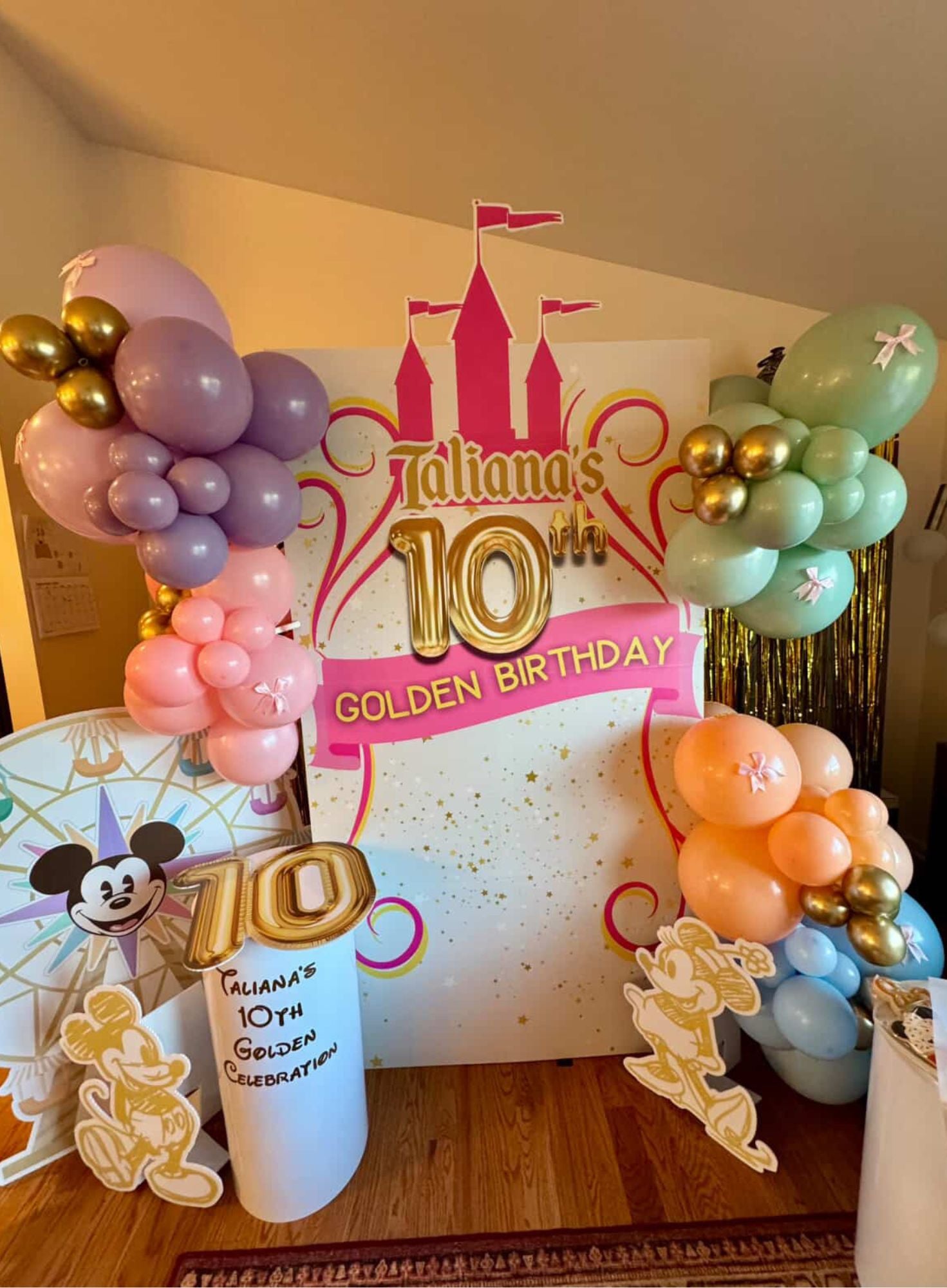 Decorative setup for Taliana's 10th Golden Birthday with balloons and a castle-themed backdrop for a 10 year old birthday party in Atlanta.