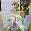 Children's birthday cake with castle design and number 3 topper, outdoor setting for a 3 year old birthday party.