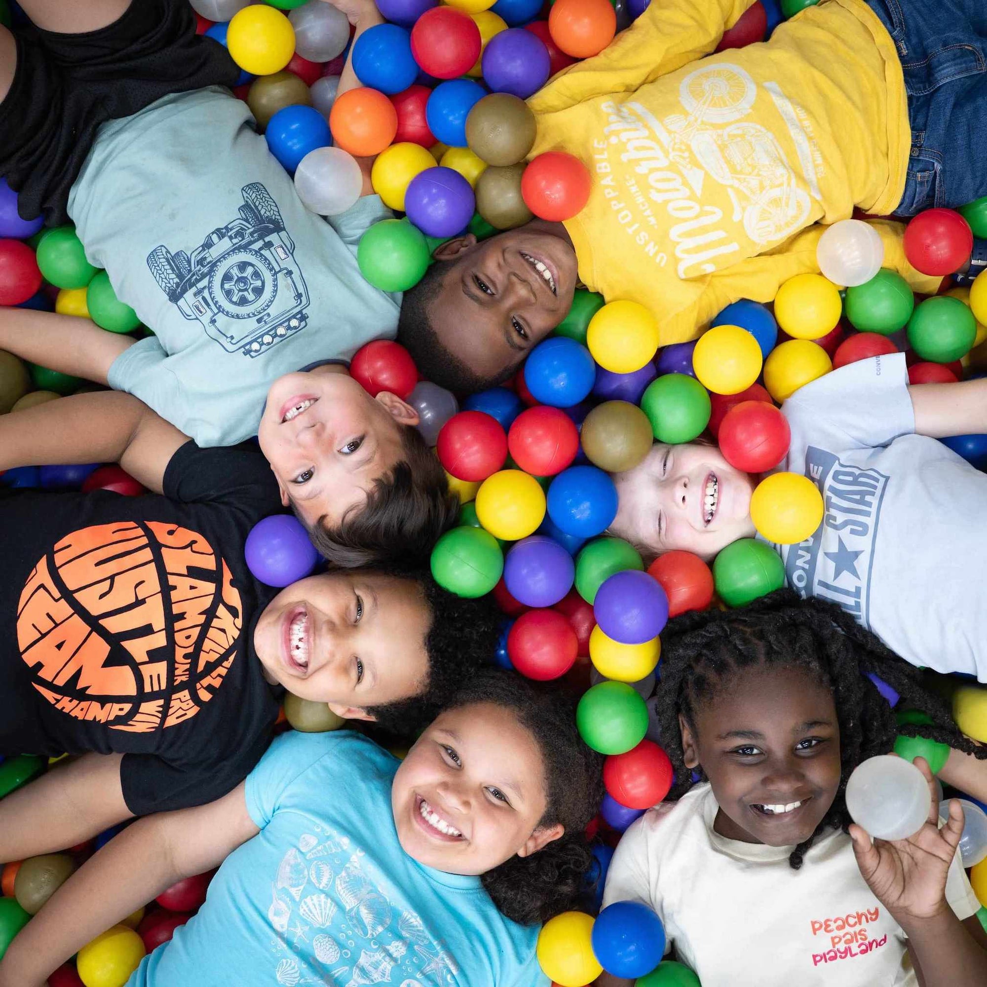 Children playing with colorful balls in a ball pit at Peachy Pals Playland Cartersville GA | Confetti Jar
