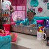 Child playing with makeup and toys at a spa bus party.