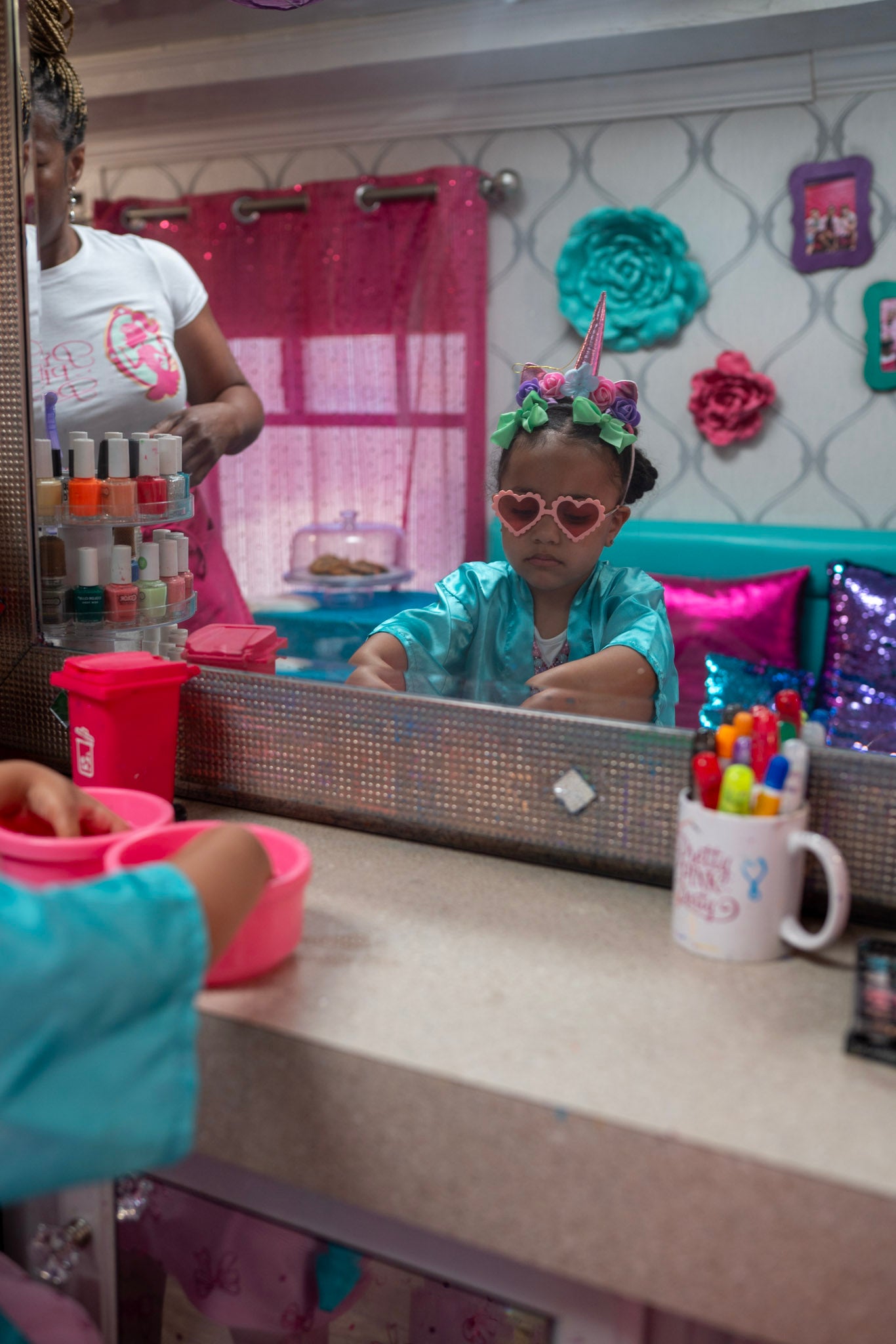 Child playing with makeup and toys at a spa bus party.