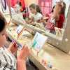 Child painting a canvas at a girls birthday party in Atlanta.
