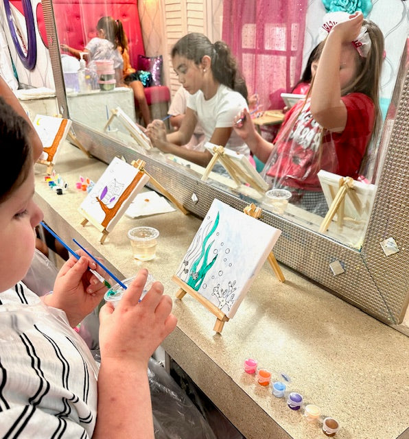Child painting a canvas at a girls birthday party in Atlanta.