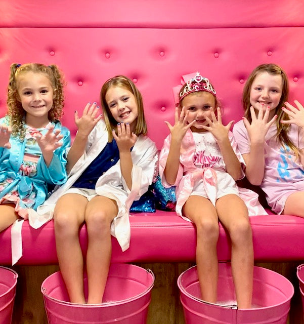Four young girls at a spa bus party in Atlanta.