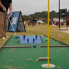Child playing mini golf on a course with a green background for a community event in Atlanta GA | Confetti Jar