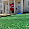 Green artificial grass for a mobile mini golf in front of a large white building with columns | Confetti Jar