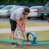 Man and child playing mini golf on a mobile putt putt course in Atlanta for a birthday party | Confetti Jar