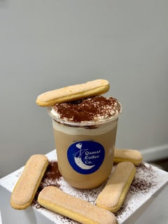 Cup of coffee with cookies on a white surface