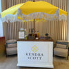 Kendra Scott display with yellow canopy and product display inside a room | Dessert Cart Atlanta | Confetti Jar