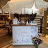 Baby shower setup with a decorated table and canopy in a home interior | Dessert Cart Atlanta | Confetti Jar