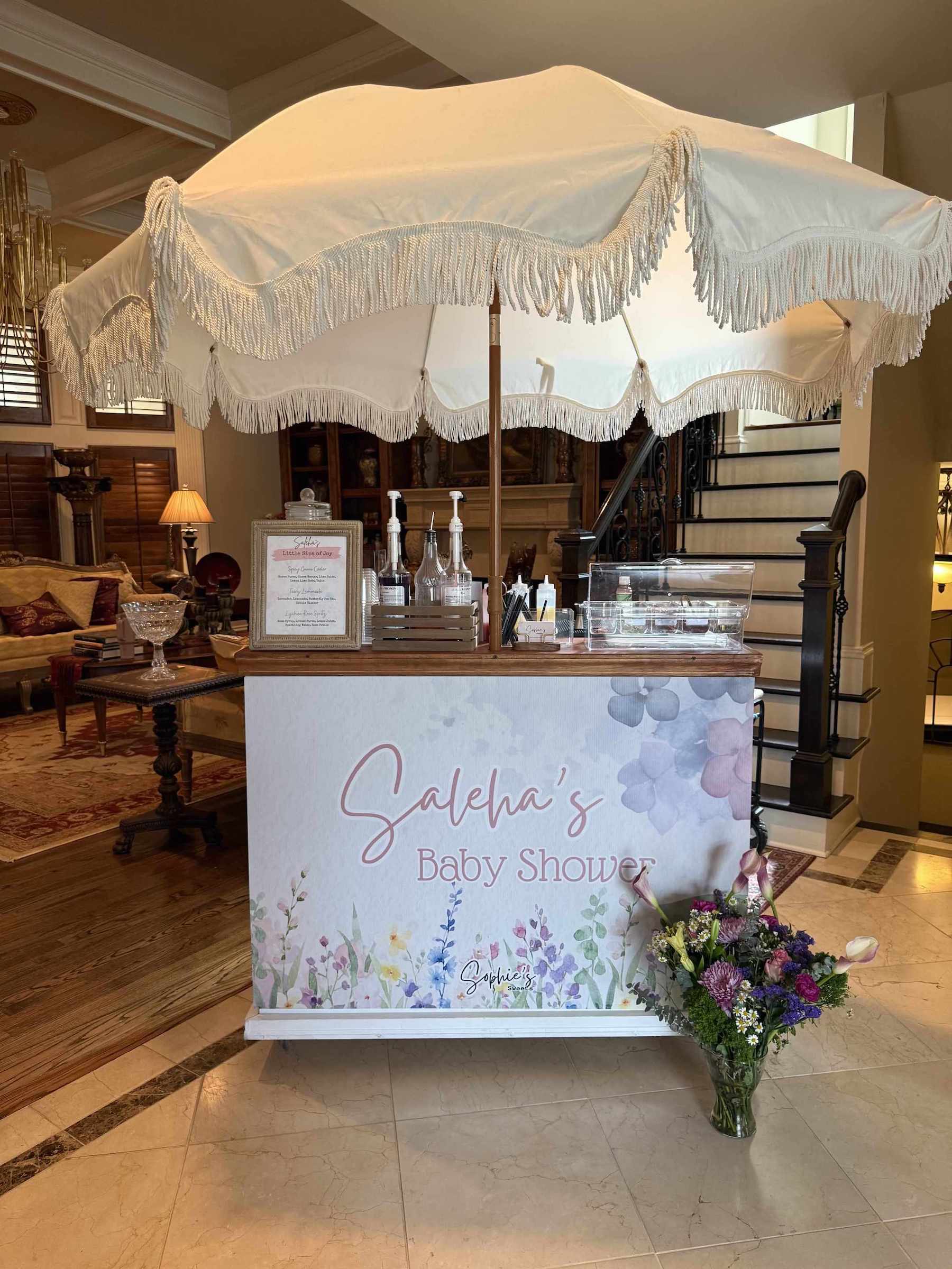 Baby shower setup with a decorated table and canopy in a home interior | Dessert Cart Atlanta | Confetti Jar