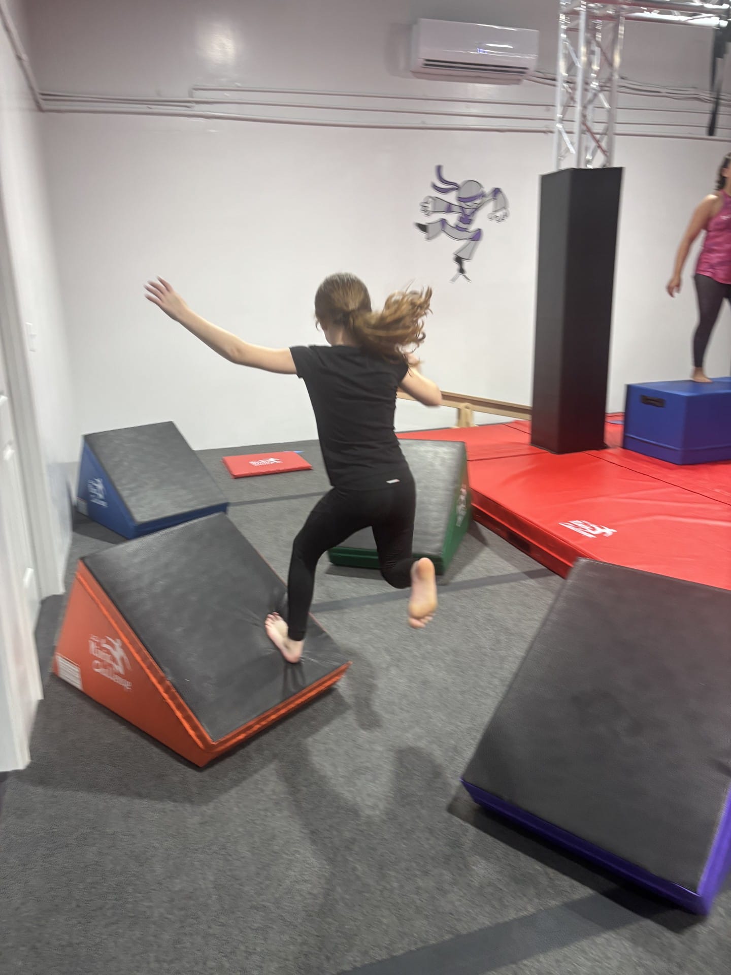 Girl Jumping through Ninja Warrior Course Woodstock | Confetti Jar