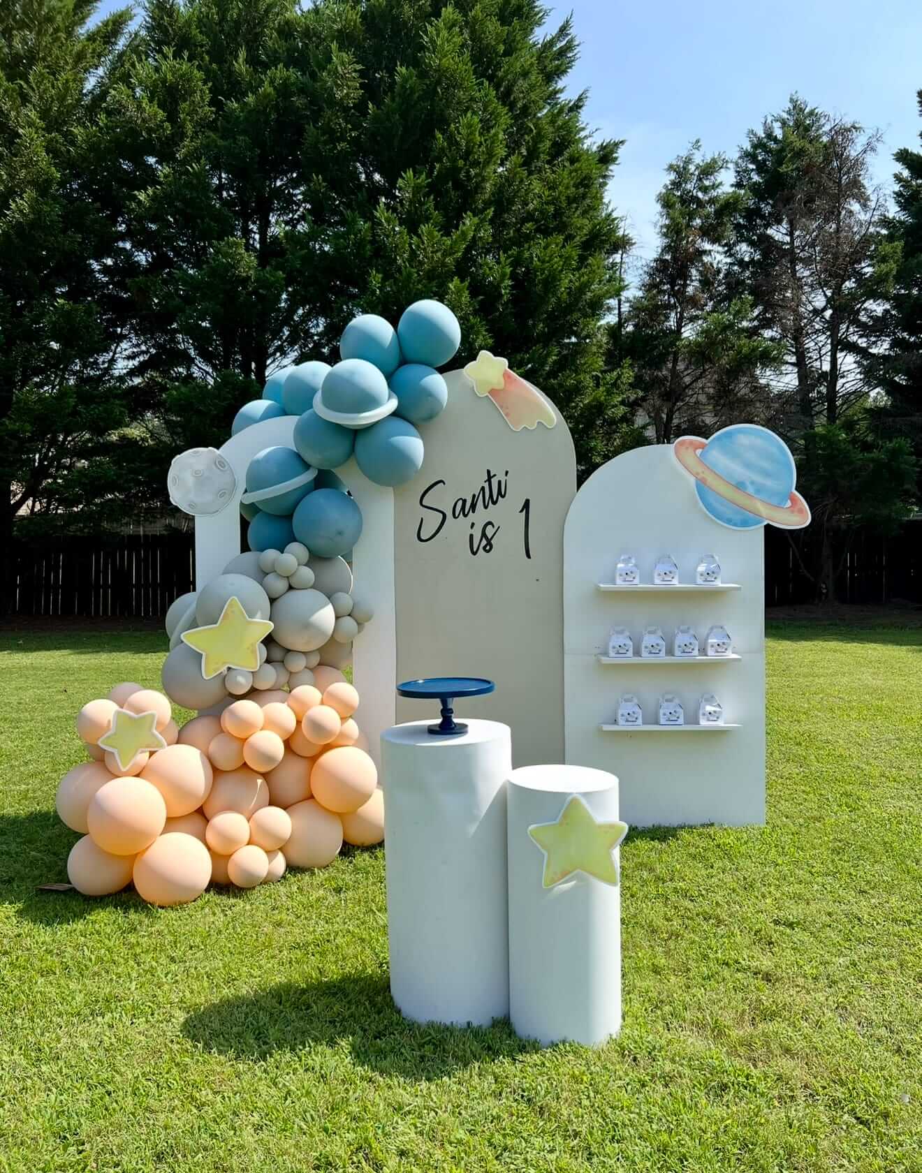 Decorative arch with balloons and personalized name display outdoors at a birthday party in Atlanta.