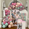 Decorative arch with balloons and photo display at a birthday party in Atlanta.