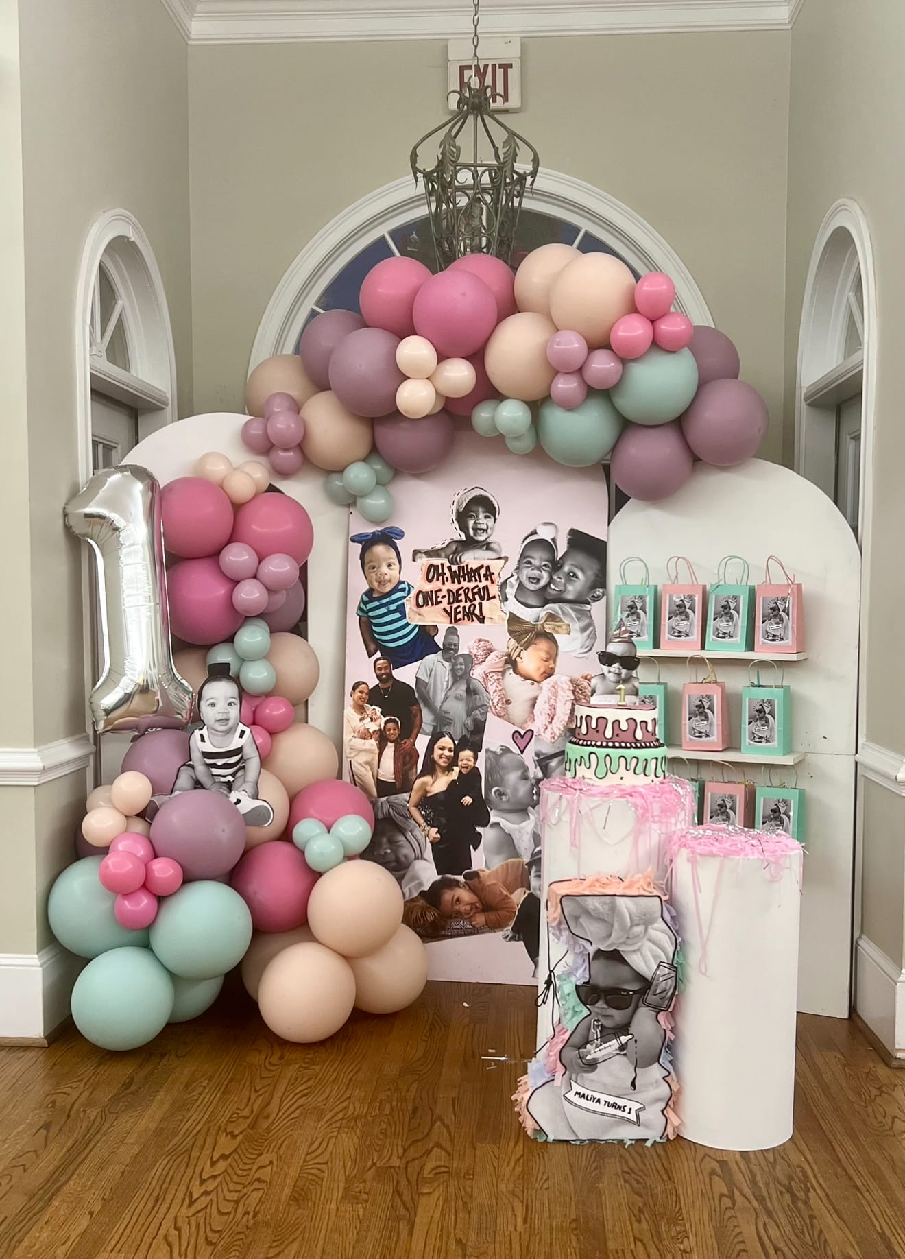 Decorative arch with balloons and photo display at a birthday party in Atlanta.
