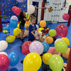 Children playing with colorful balloons in a room with play equipment at a birthday party for kids in Atlanta | Confetti Jar